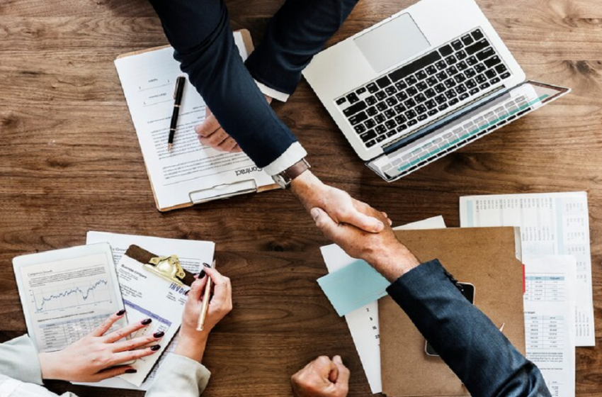 business people shaking hands together